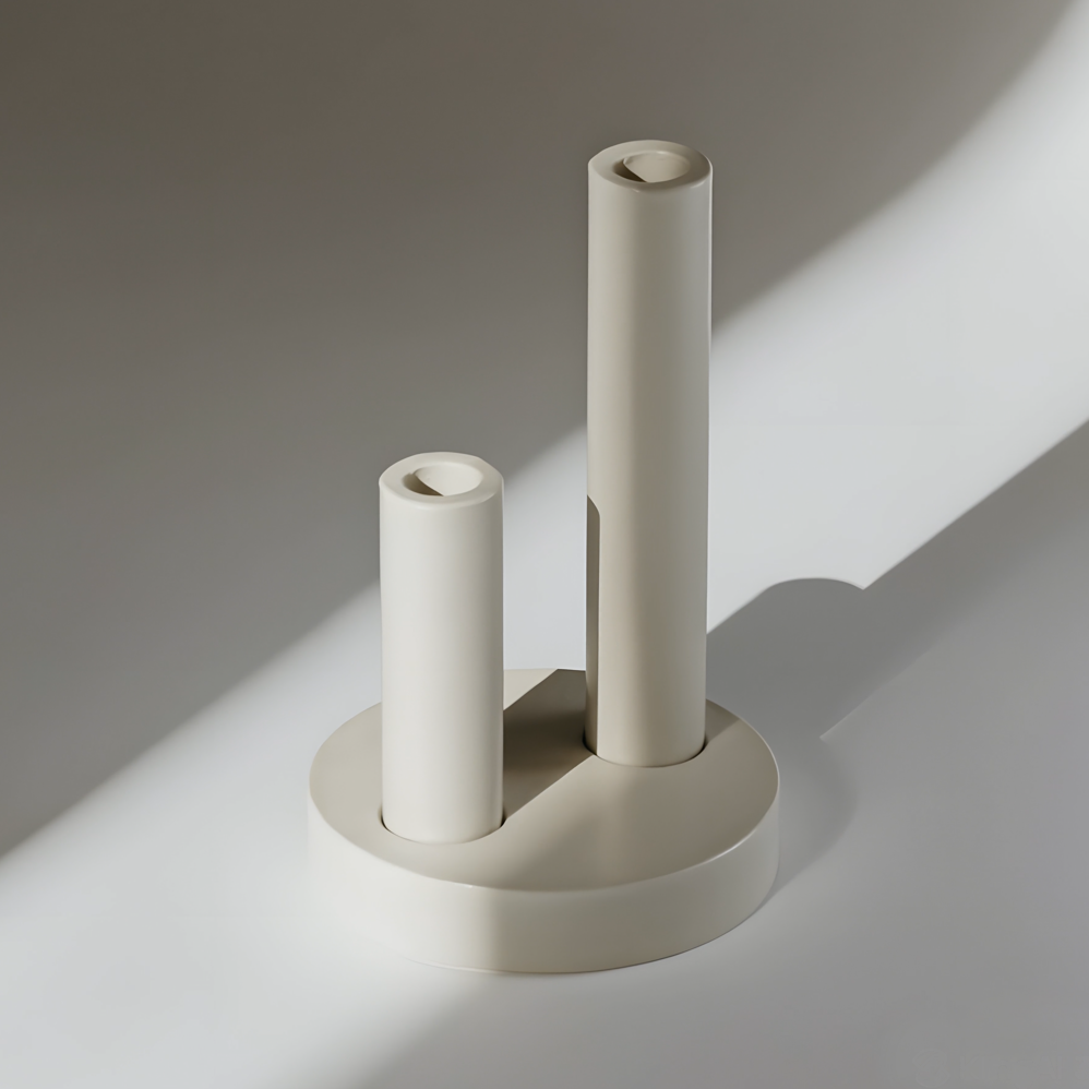 Artisanal double pillar plaster candle holder displaying structural geometry for high-end minimalist interior design projects and contemporary space staging.