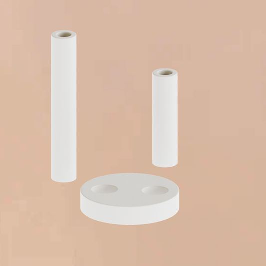 Handmade minimalist plaster double pillar candle holder showing its disassembled two staggered cylindrical columns and unique curved round base component