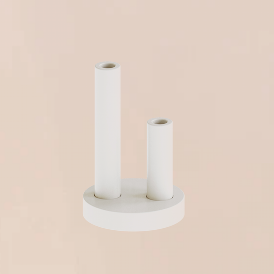 CAST sculptural plaster double pillar candle holder with round base styled as a minimalist homeware object on a soft backdrop