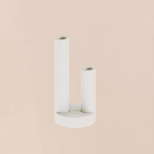 CAST sculptural plaster double pillar candle holder with moon base styled as a minimalist homeware object on a soft peach backdrop
