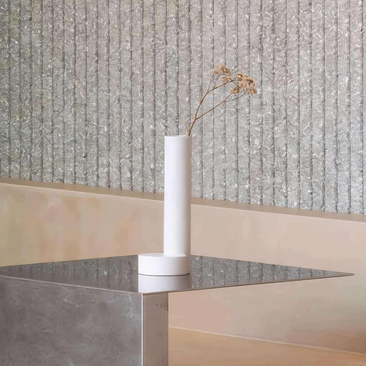 CAST sculptural plaster vase with moon base holding a dried flower stem in a minimalist Japandi style room arrangement