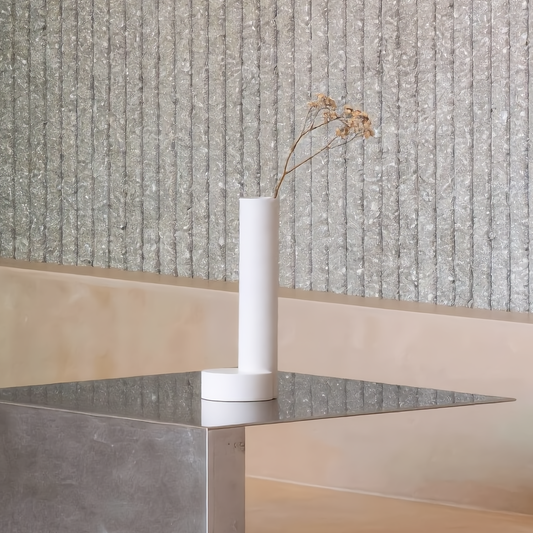 CAST sculptural plaster vase with moon base holding a dried flower stem in a minimalist Japandi style room arrangement